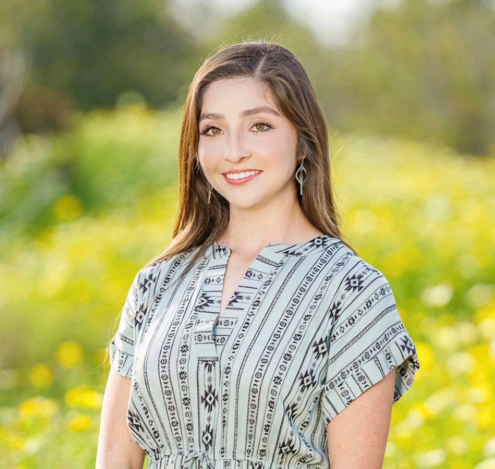 a woman smiles at the camera